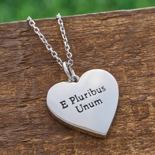 American flag heart pendant necklace back view engraved with E Pluribus Unum on rustic wood